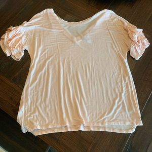 Light pink T-shirt with v neckline in the back.